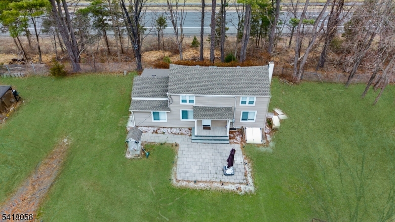 28 Wagners Lane Warren, NJ 07059 - Photo 6 of 50 a aerial view of a house with a yard table and chairs