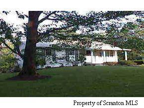 1050 Swoyer Road Lake Ariel, PA 18436 - Photo 2 of 7 a front view of a house with a garden