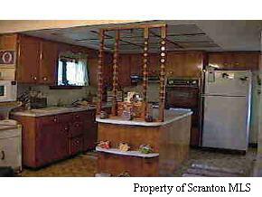 1050 Swoyer Road Lake Ariel, PA 18436 - Photo 3 of 7 a kitchen with a refrigerator and a sink