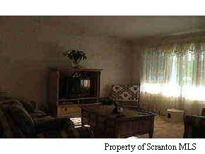 1050 Swoyer Road Lake Ariel, PA 18436 - Photo 4 of 7 a living room with furniture and a fireplace