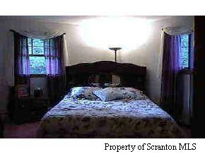 1050 Swoyer Road Lake Ariel, PA 18436 - Photo 5 of 7 a bed sitting in a bedroom next to a window