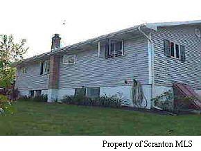 1050 Swoyer Road Lake Ariel, PA 18436 - Photo 6 of 7 a front view of a house with a garden