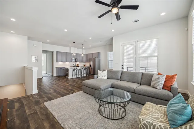 a living room with furniture and a wooden floor