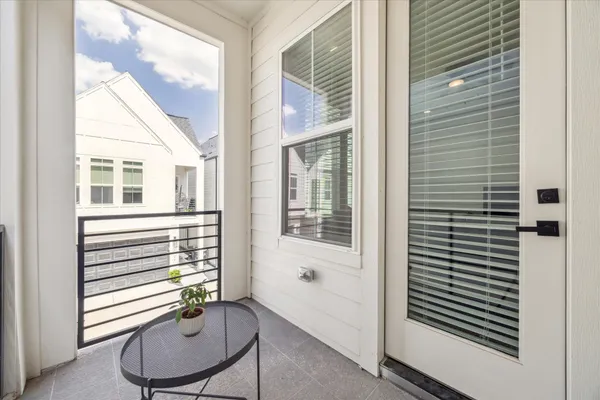 a view of a room with furniture and windows