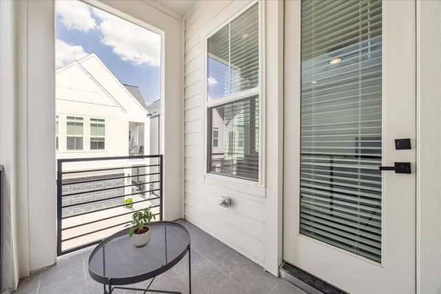 a view of a room with furniture and windows