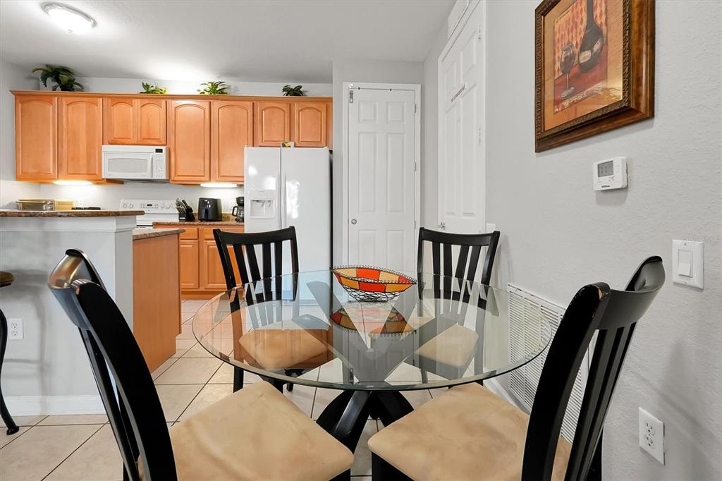 5036 Shoreway Loop, Unit 30105 Orlando, FL 32819 - Photo 11 of 49 a view of a dining room with furniture window and wooden floor