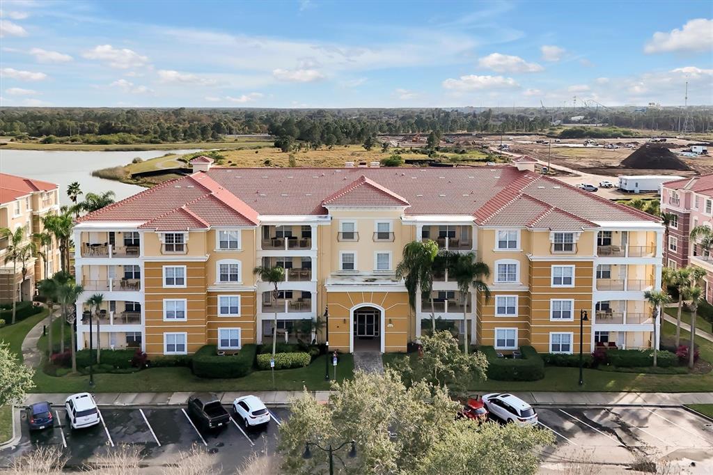 5036 Shoreway Loop, Unit 30105 Orlando, FL 32819 - Photo 2 of 49 a front view of a residential apartment building with a yard