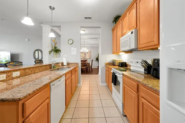 a view of a dining room with furniture wooden floor and chandelier