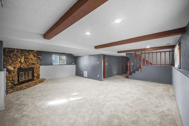 a view of empty room with a fireplace