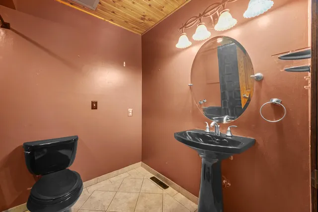 a view of a livingroom with furniture and a mirror