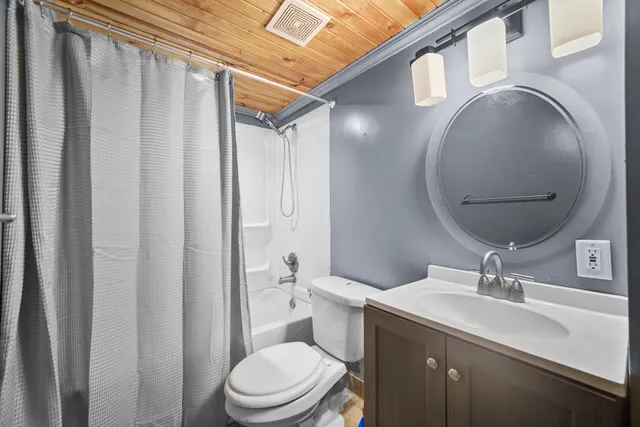 a bathroom with a toilet a sink and a mirror