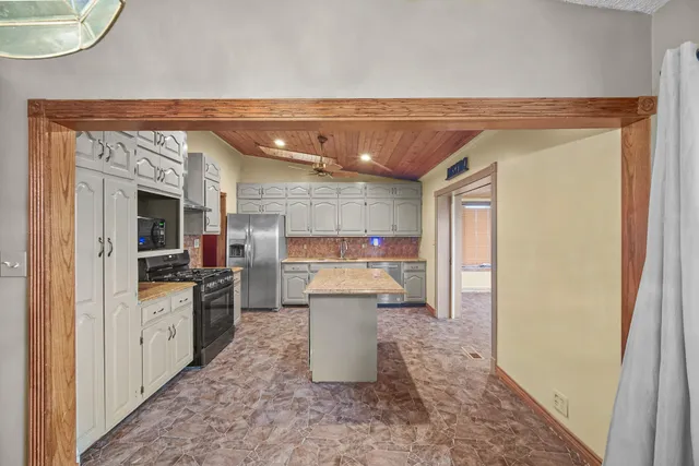 a kitchen with a refrigerator and a sink