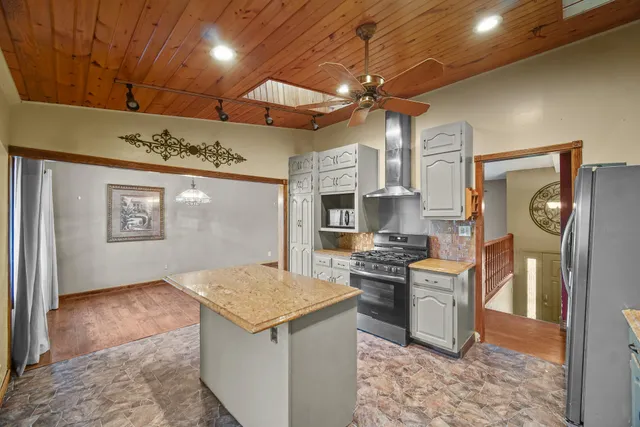 a kitchen with stainless steel appliances granite countertop a sink and cabinets