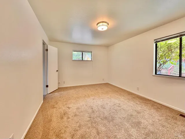 a living room with furniture a fireplace and a large window