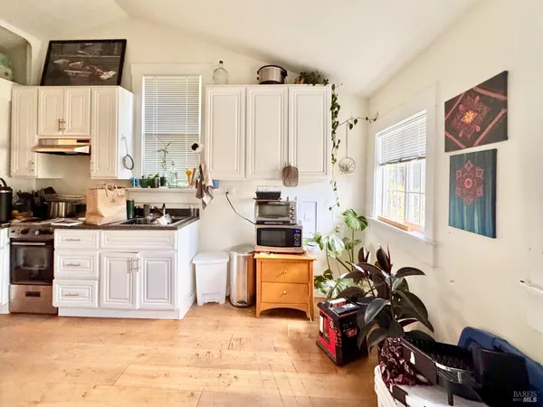 a kitchen with stainless steel appliances a sink cabinets and a window