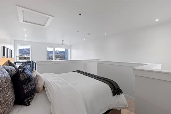 a view of a hallway with furniture and windows