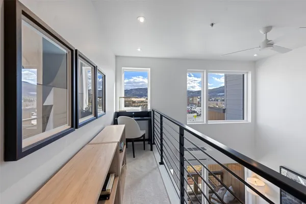 a view of a balcony with chair and wooden floor