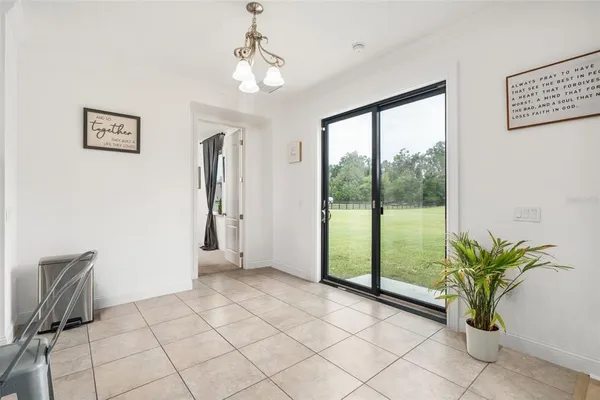 a large kitchen with stainless steel appliances granite countertop a sink and a microwave