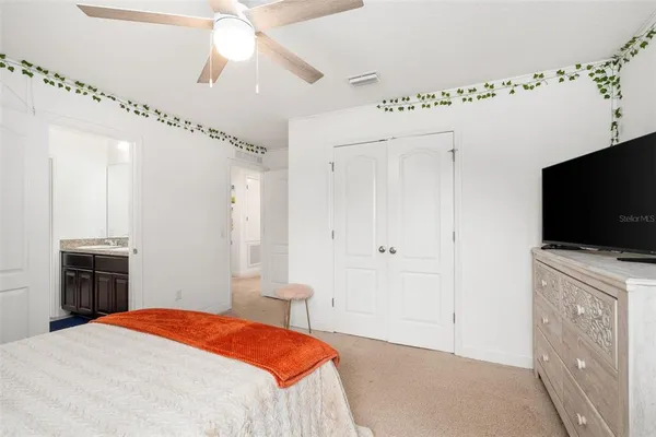 a kitchen with a refrigerator and white cabinets