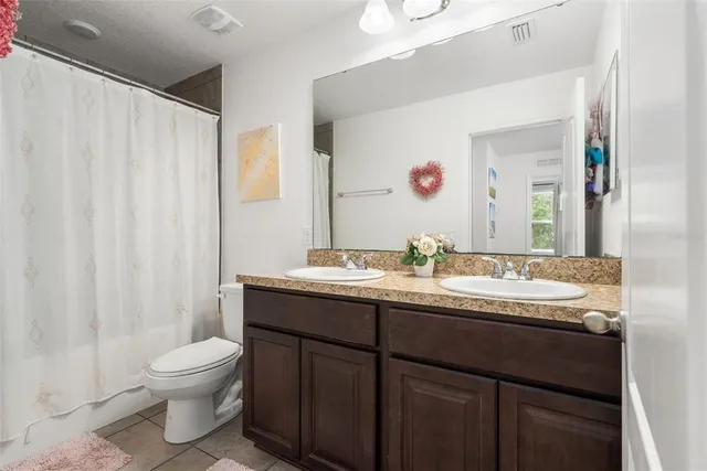 a spacious bedroom with a bed and a flat screen tv