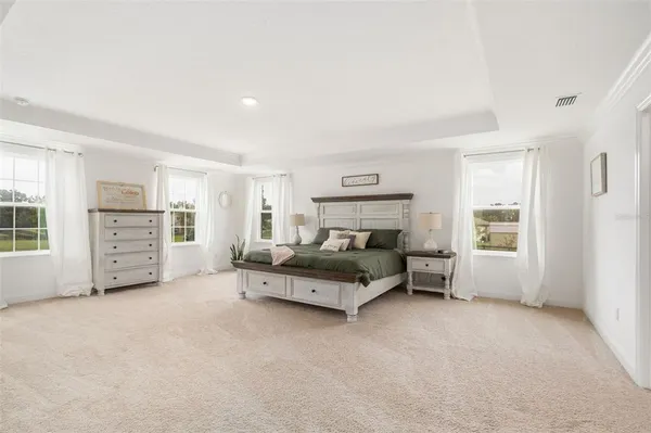 a spacious bathroom with a granite countertop sink a toilet a mirror and shower