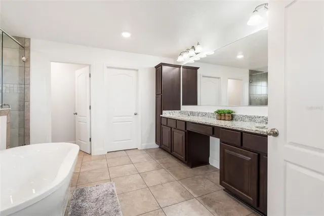 a view of walk in closet with clothes