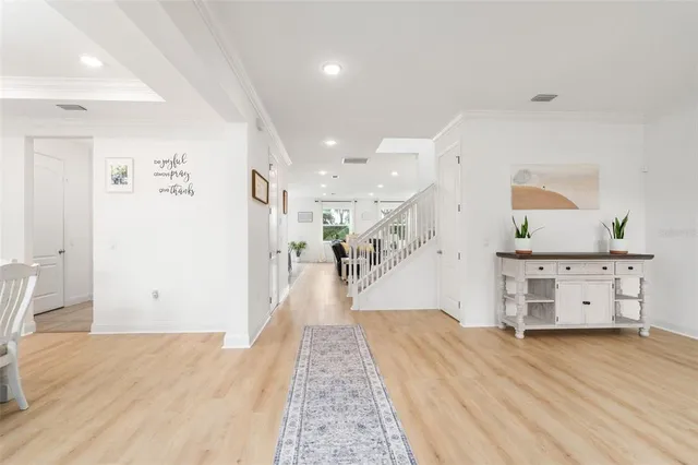 a view of a hallway with wooden floor