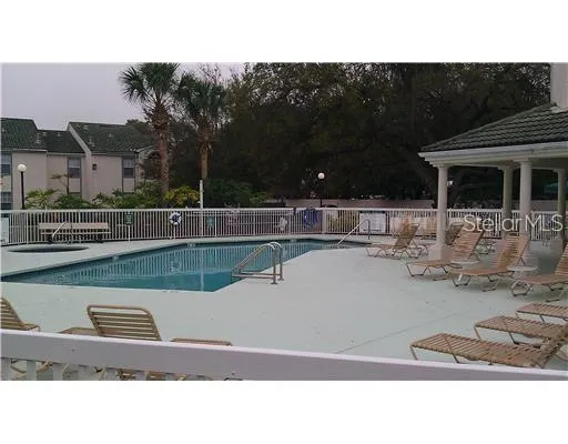 a view of swimming pool with outdoor seating and plants