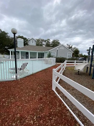 a view of a house with wooden deck