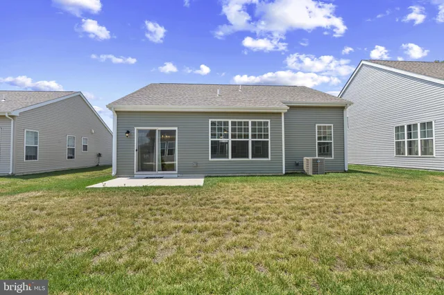 a backyard of a house with yard and outdoor seating
