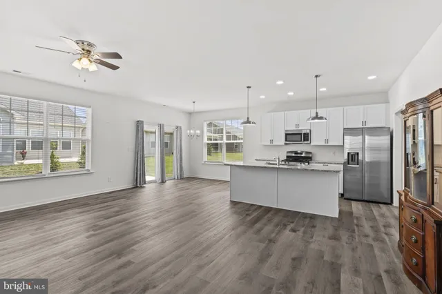 a living room with kitchen view and living room view