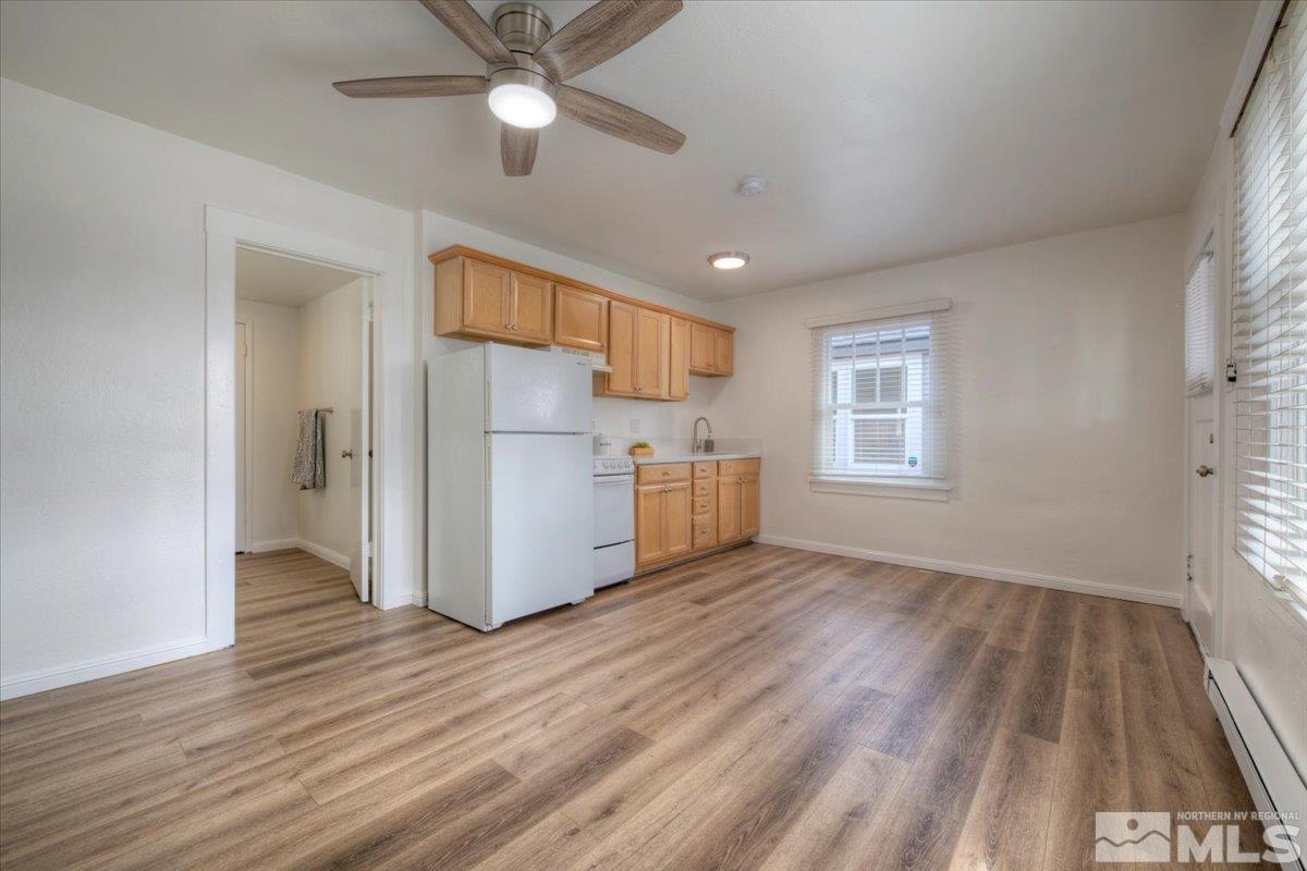 485 East 7th Street Reno, NV 89512 - Photo 15 of 31 a view of a kitchen with a fridge wooden floor and a window
