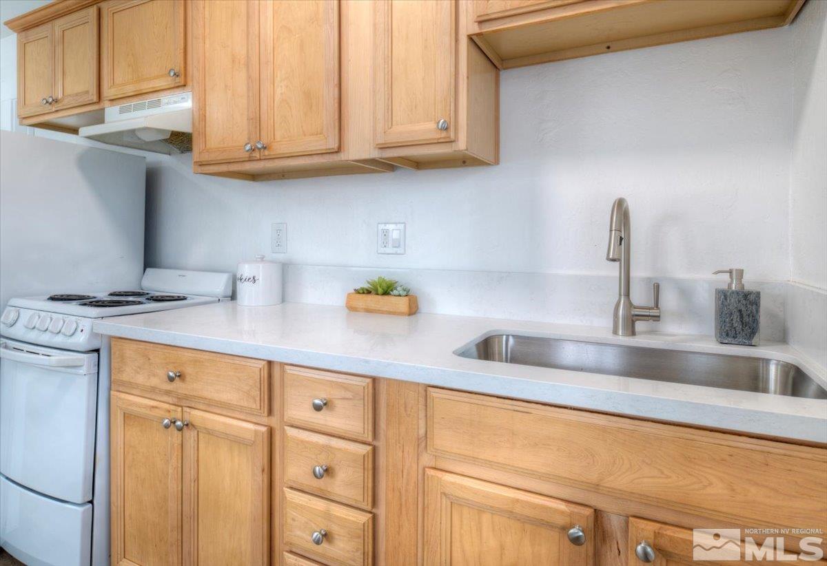 485 East 7th Street Reno, NV 89512 - Photo 16 of 31 a kitchen with stainless steel appliances granite countertop a sink and cabinets