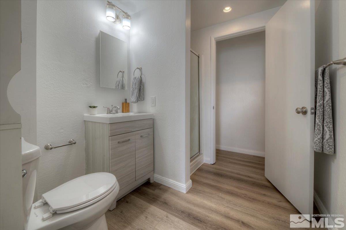 485 East 7th Street Reno, NV 89512 - Photo 17 of 31 a bathroom with a sink a toilet a mirror and vanity