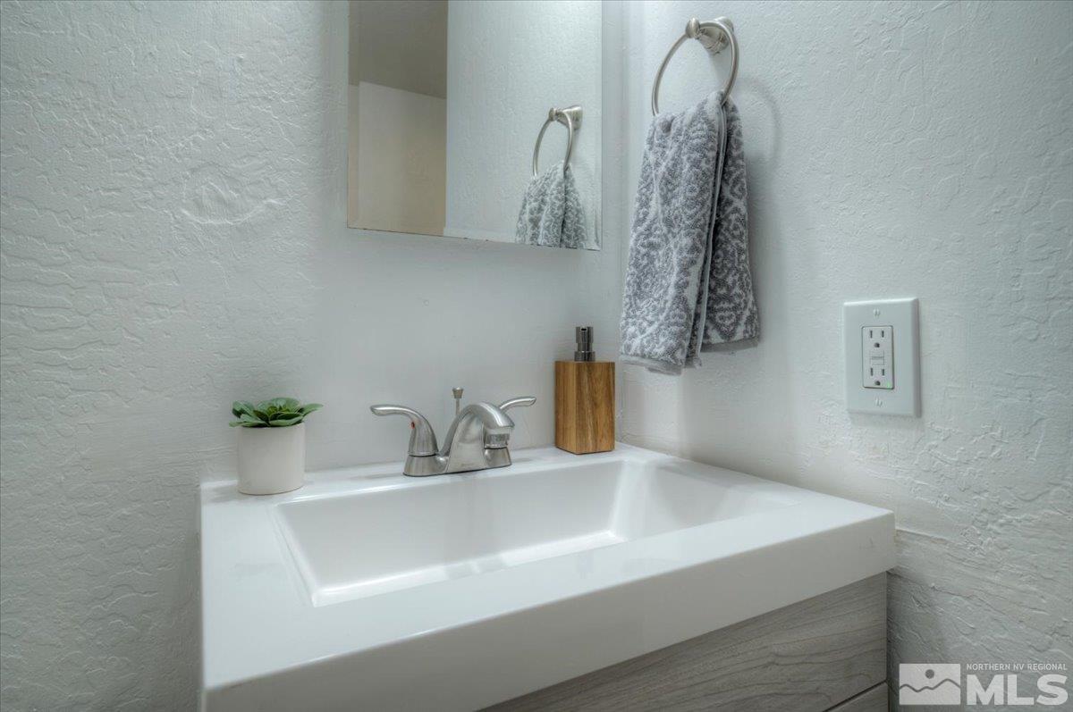 485 East 7th Street Reno, NV 89512 - Photo 18 of 31 a bathroom with a sink and a mirror
