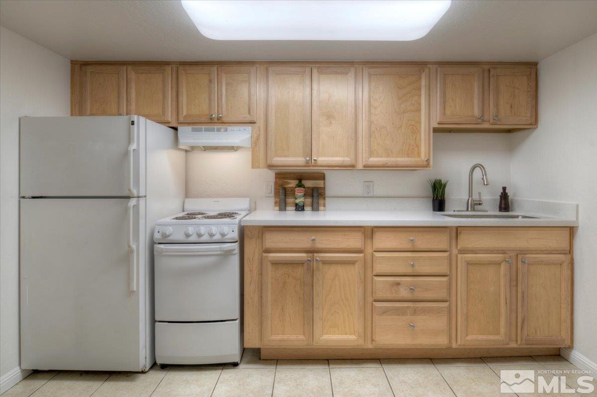 485 East 7th Street Reno, NV 89512 - Photo 26 of 31 a kitchen with stainless steel appliances granite countertop a refrigerator sink and cabinets