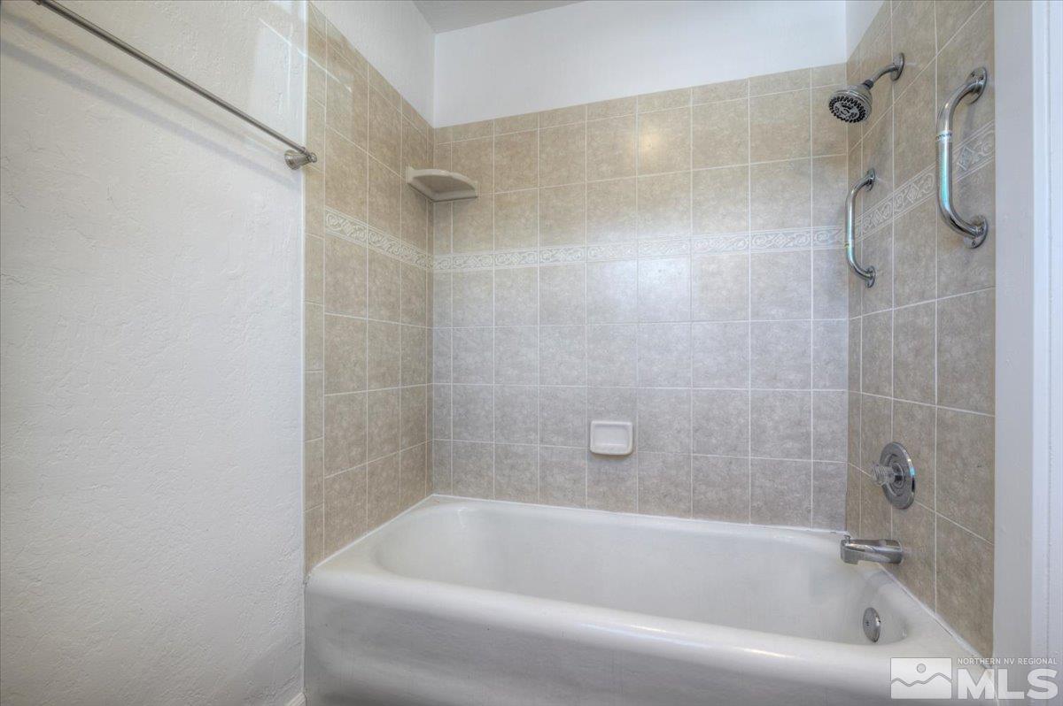 485 East 7th Street Reno, NV 89512 - Photo 29 of 31 a white bath tub sitting next to a shower