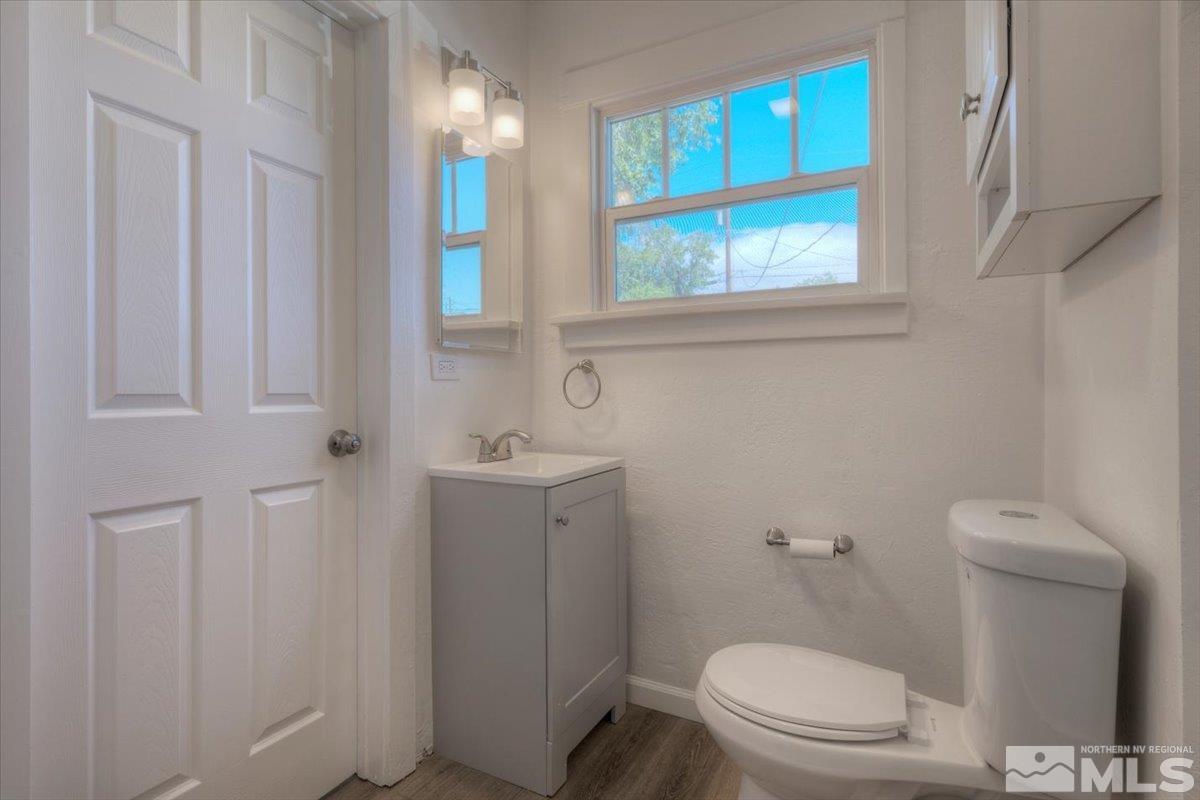 485 East 7th Street Reno, NV 89512 - Photo 30 of 31 a bathroom with a toilet a sink and a window