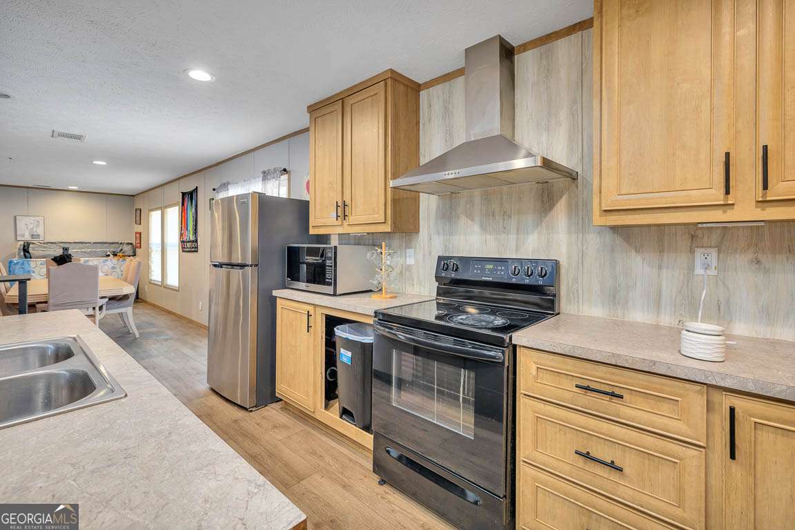 3069 Mineral Springs Road Waynesville, GA 31566 - Photo 12 of 35 a kitchen with refrigerator and cabinets