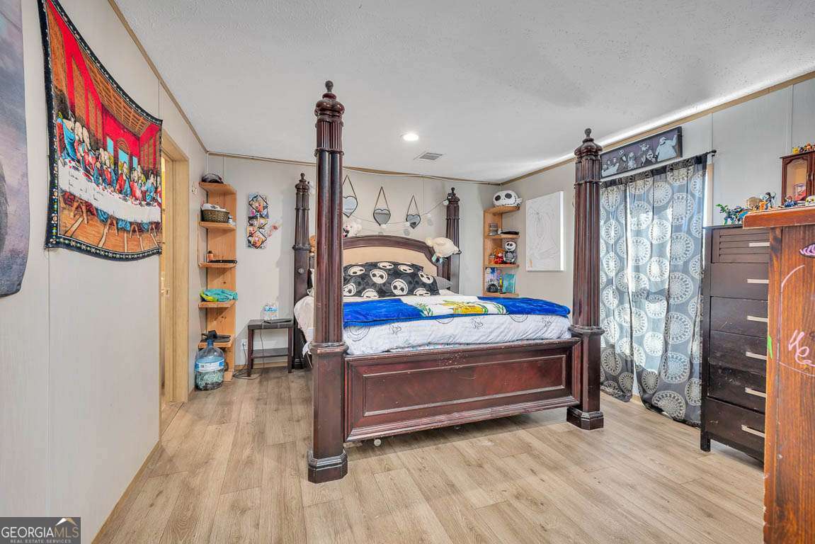 3069 Mineral Springs Road Waynesville, GA 31566 - Photo 17 of 35 a bedroom with bed and a window