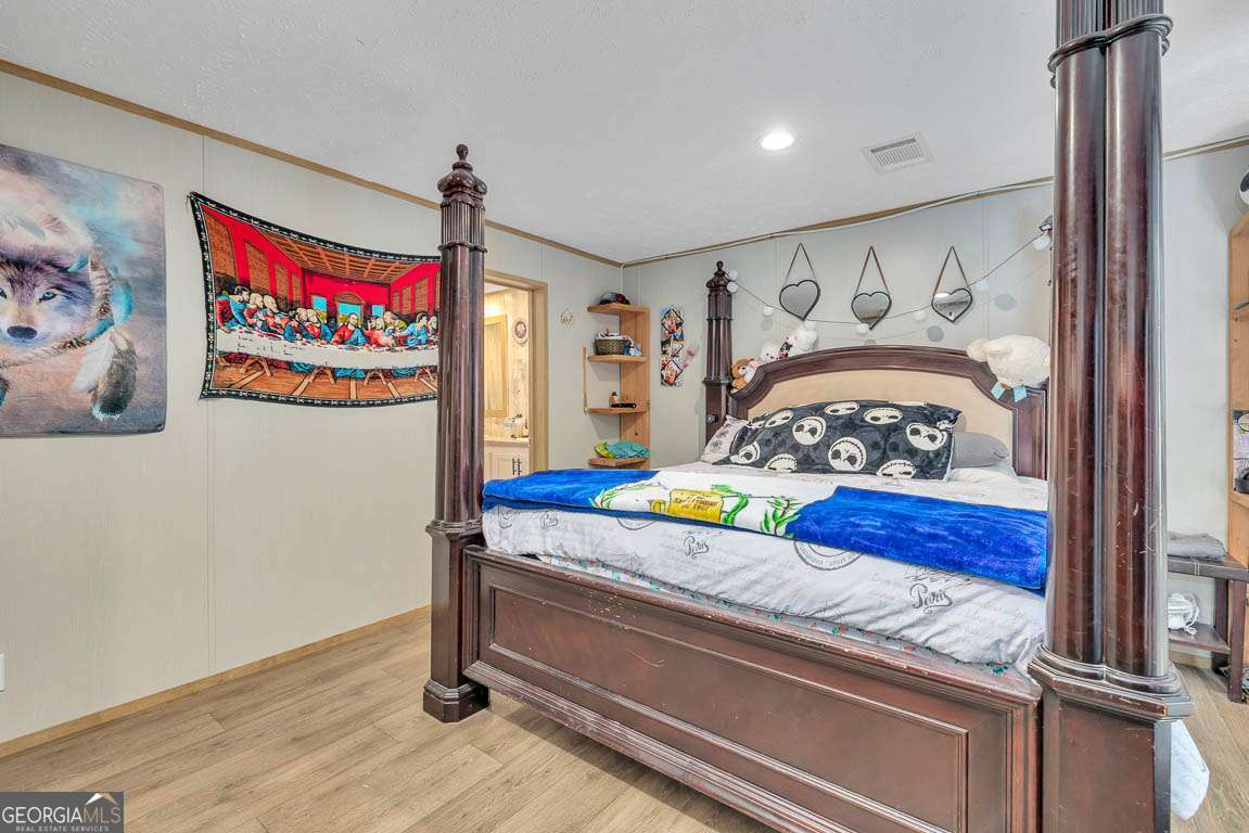 3069 Mineral Springs Road Waynesville, GA 31566 - Photo 18 of 35 a bedroom with bed and a window