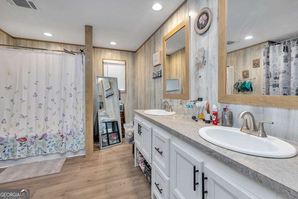 3069 Mineral Springs Road Waynesville, GA 31566 - Photo 19 of 35 a spacious bathroom with a sink double vanity and a mirror