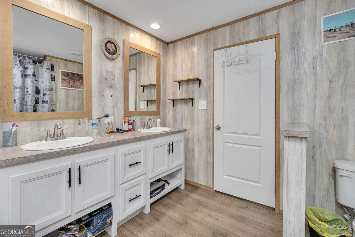 3069 Mineral Springs Road Waynesville, GA 31566 - Photo 20 of 35 a spacious bathroom with a double vanity sink a mirror and a shower