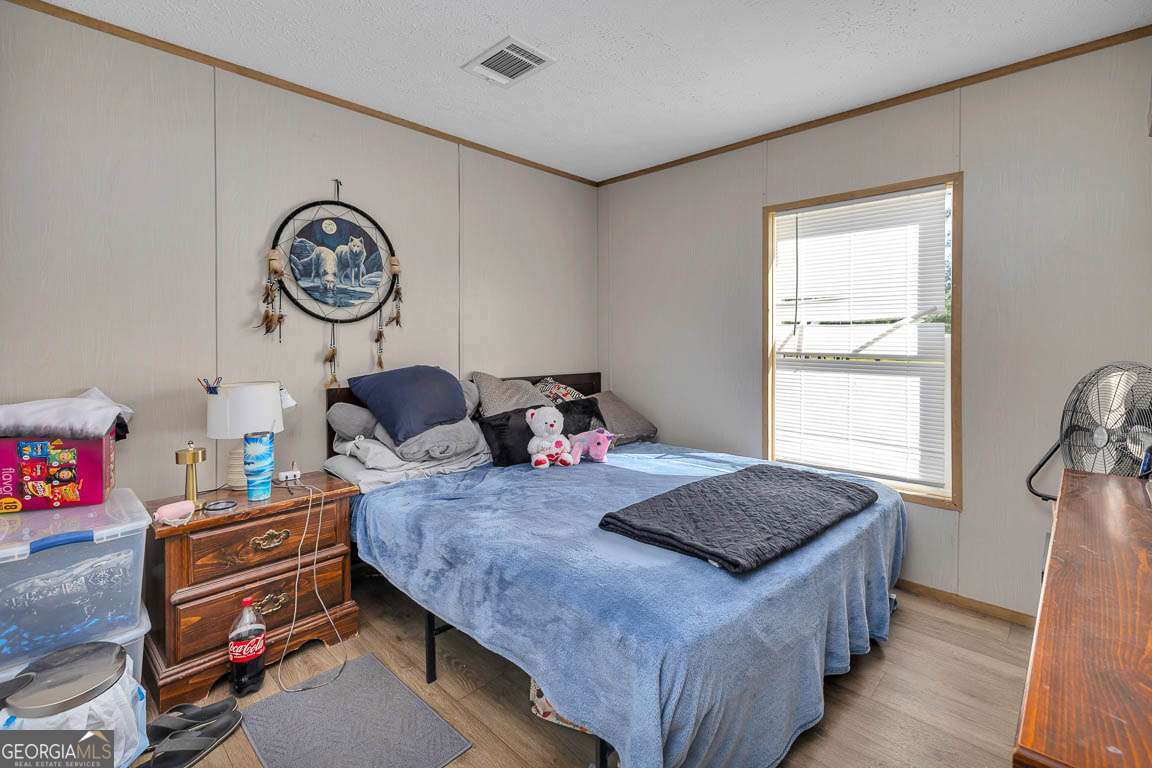 3069 Mineral Springs Road Waynesville, GA 31566 - Photo 23 of 35 a bed room with a bed and a window