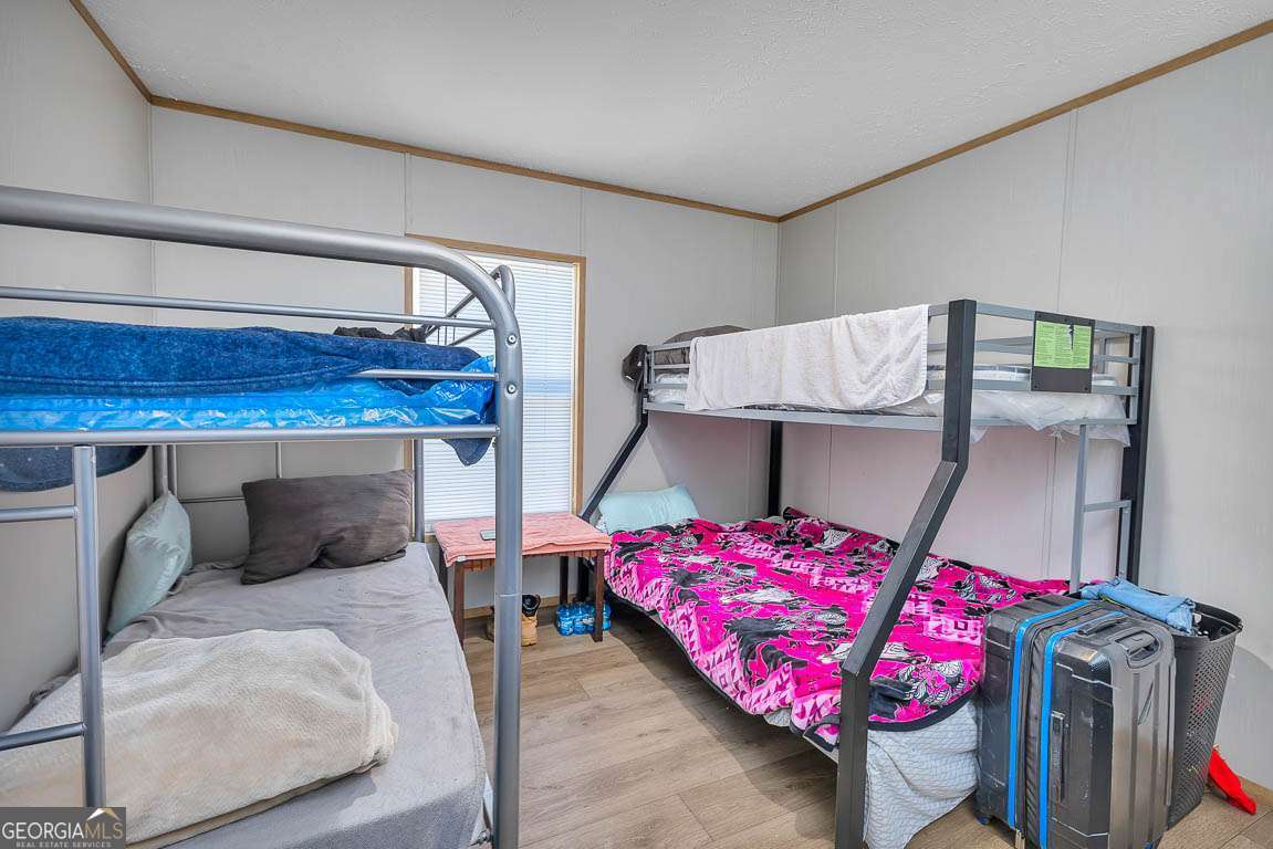 3069 Mineral Springs Road Waynesville, GA 31566 - Photo 25 of 35 a bedroom with a bed and a table