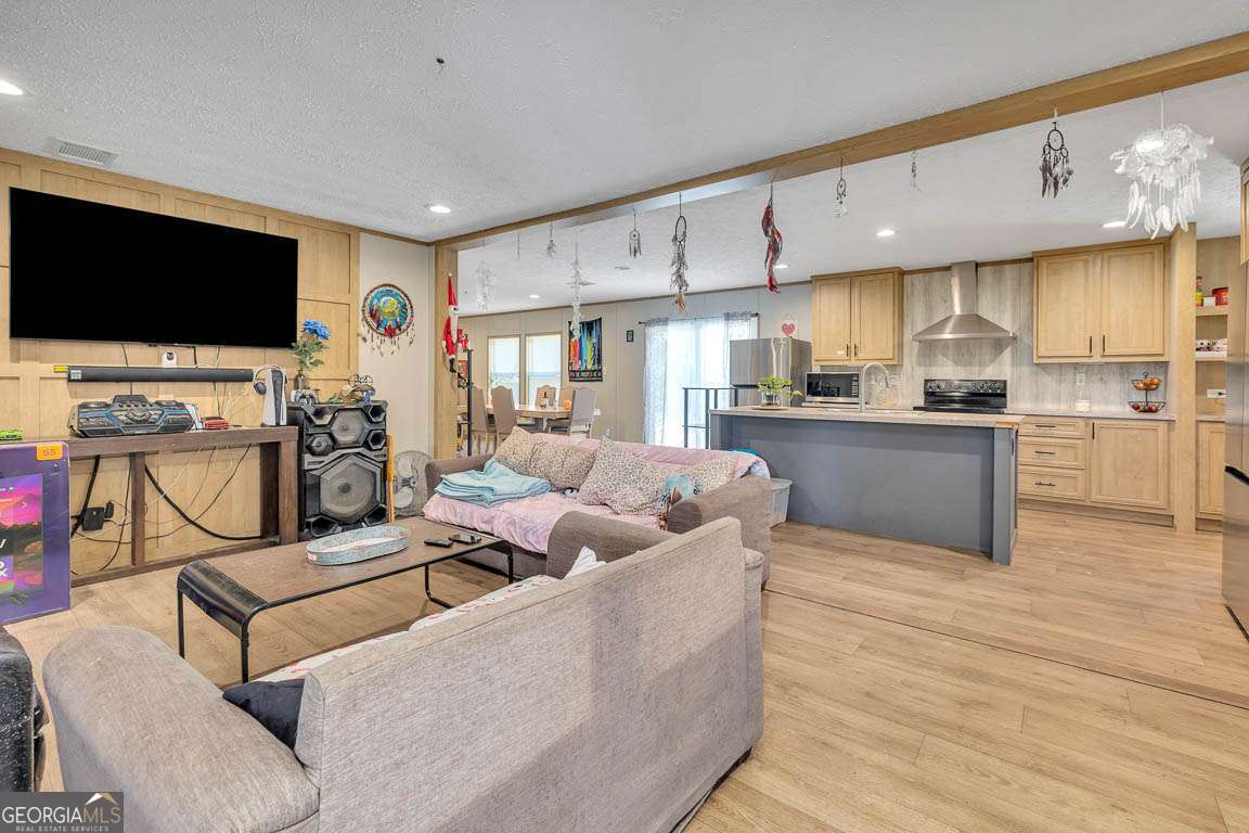 3069 Mineral Springs Road Waynesville, GA 31566 - Photo 8 of 35 a living room with stainless steel appliances furniture and a flat screen tv