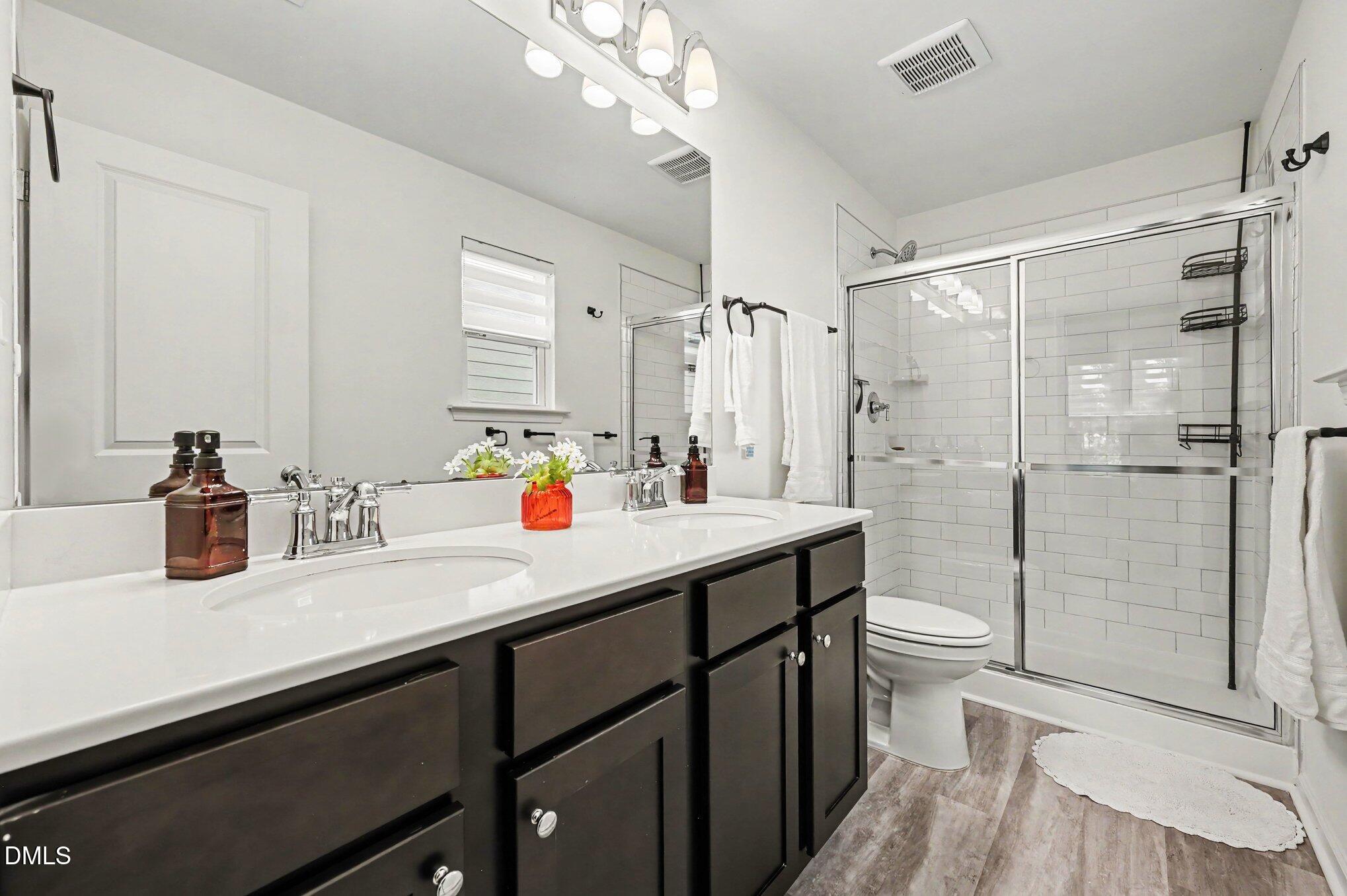 574 Hacksaw Trail Raleigh, NC 27610 - Photo 14 of 28 a bathroom with a sink a toilet and shower