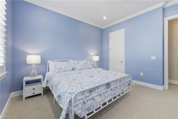a bedroom with a bed and a lamp