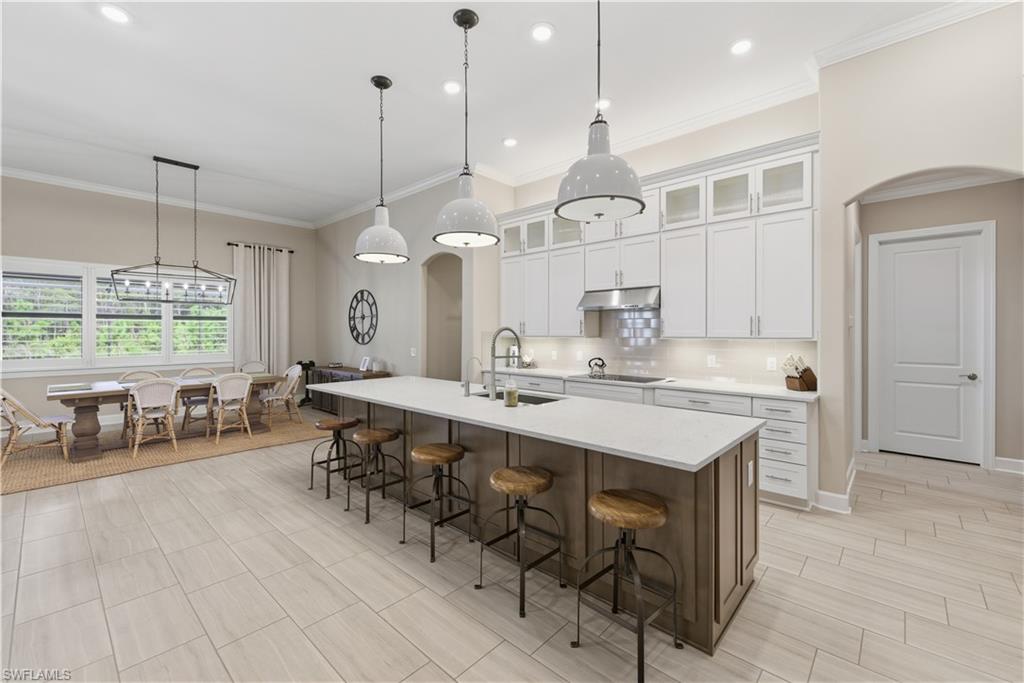 19074 Elston Way Estero, FL 33928 - Photo 14 of 50 a large kitchen with a table and chairs