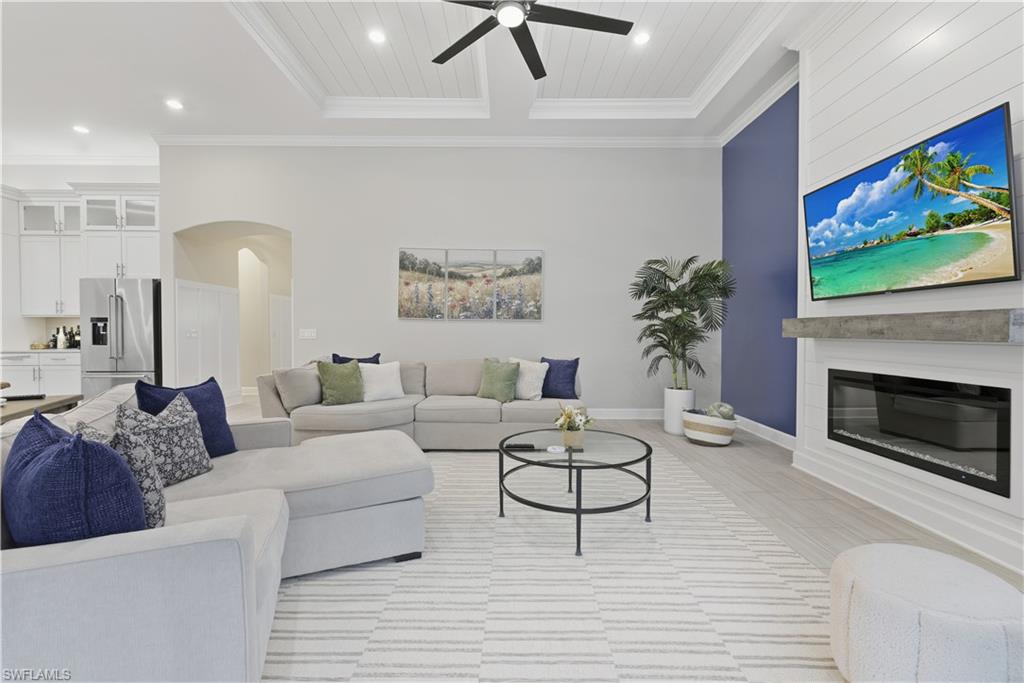 19074 Elston Way Estero, FL 33928 - Photo 21 of 50 a living room with furniture a fireplace and a flat screen tv